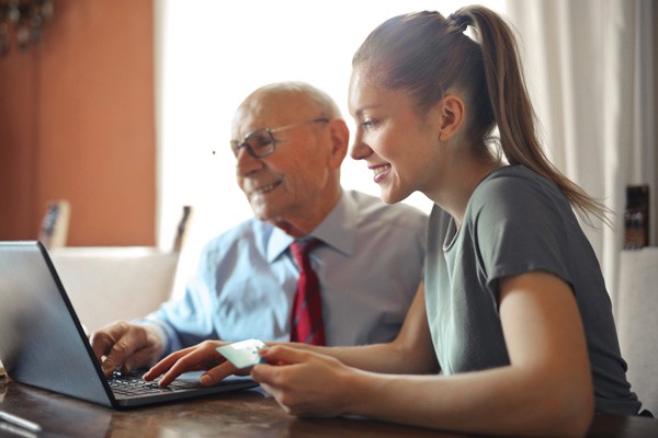 Professional helping a young woman at the computer