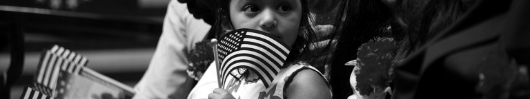Small immigrant child with American flag