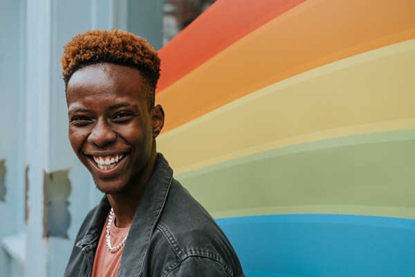 Young man in front of a colorful background