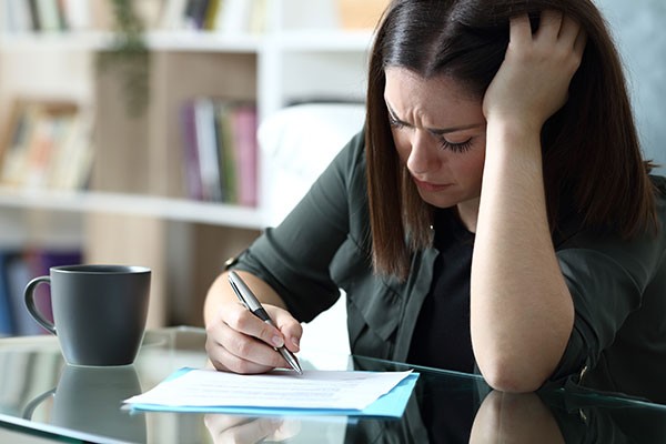 Stressed woman filling out a petition