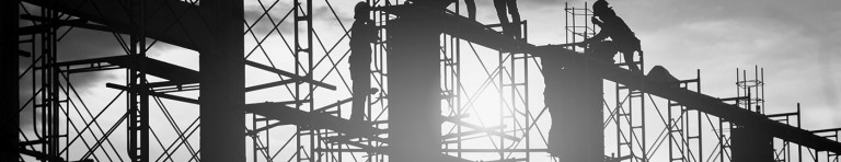 Workers doing construction at sunset